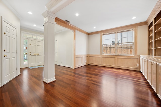 1938 Norfolk St, Houston, TX 77098 - entrance foyer featuring ornate columns, ornamental molding, dark wood-style flooring, wainscoting, and a decorative wall