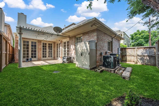 1938 Norfolk St, Houston, TX 77098 - rear view of property with french doors, brick siding, a patio, and central air condition unit