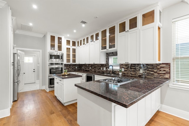 1509 Summer St, Houston, TX 77007 - kitchen featuring appliances with stainless steel finishes, baseboards, a peninsula, backsplash, and wine cooler