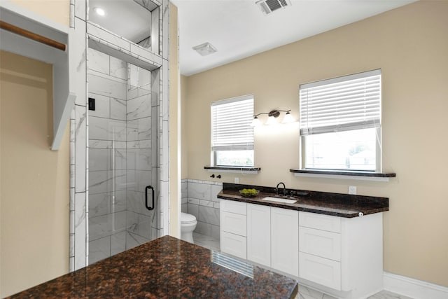 1509 Summer St, Houston, TX 77007 - bathroom featuring toilet, a marble finish shower, marble look tiles, and vanity