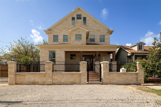 1509 Summer St, Houston, TX 77007 - view of front of house featuring a porch, a gate, stone siding, and a fenced front yard
