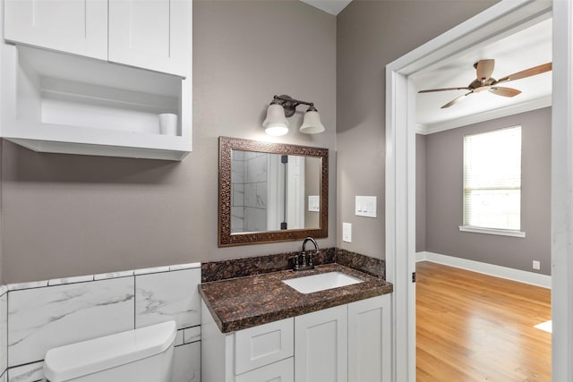 1509 Summer St, Houston, TX 77007 - bathroom featuring toilet, crown molding, vanity, wood finished floors, and a ceiling fan