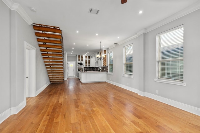 1509 Summer St, Houston, TX 77007 - unfurnished living room featuring a chandelier, crown molding, baseboards, recessed lighting, and light wood finished floors