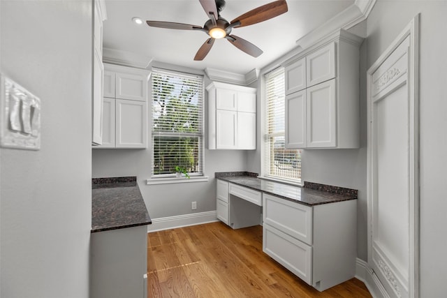 1509 Summer St, Houston, TX 77007 - kitchen featuring white cabinetry, baseboards, ceiling fan, dark stone counters, and light wood-type flooring