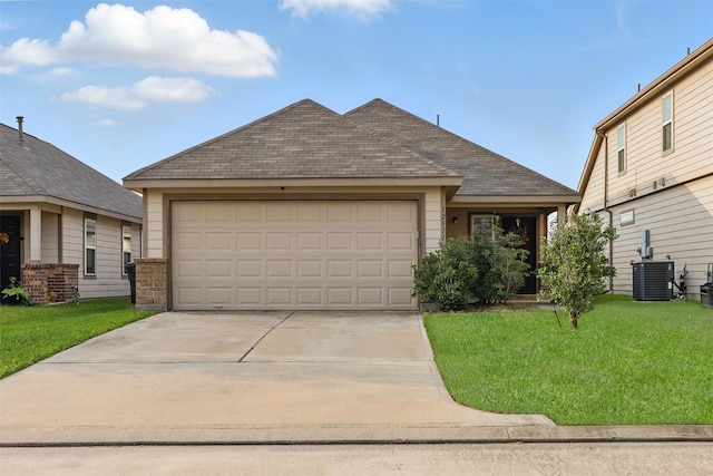 12911 Italian Cypress Trl, Houston, TX 77044 - view of front of home with central AC unit, driveway, a front yard, a garage, and brick siding