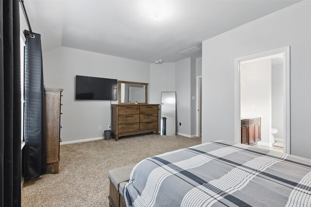12911 Italian Cypress Trl, Houston, TX 77044 - bedroom with light colored carpet, baseboards, and ensuite bath