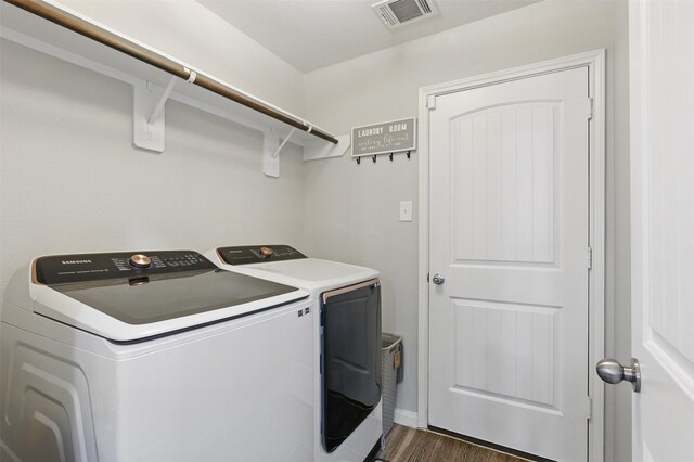 12911 Italian Cypress Trl, Houston, TX 77044 - laundry area featuring separate washer and dryer, dark wood finished floors, and baseboards