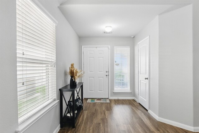 12911 Italian Cypress Trl, Houston, TX 77044 - entryway with baseboards and dark wood finished floors