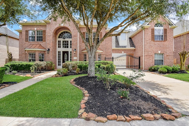 1611 Whitfield St, Sugar Land, TX 77479 - traditional home featuring a gate, driveway, and brick siding