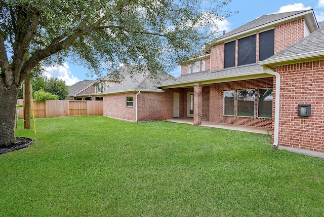 1611 Whitfield St, Sugar Land, TX 77479 - rear view of property featuring brick siding, roof with shingles, and a patio area