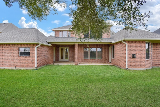 1611 Whitfield St, Sugar Land, TX 77479 - back of property with a shingled roof, a yard, brick siding, and a patio area