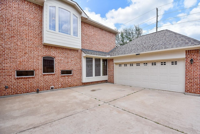 1611 Whitfield St, Sugar Land, TX 77479 - view of home's exterior featuring concrete driveway, brick siding, a garage, and a shingled roof