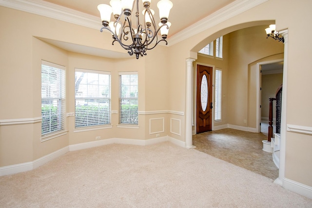 1611 Whitfield St, Sugar Land, TX 77479 - carpeted entrance foyer featuring arched walkways, a chandelier, and ornamental molding
