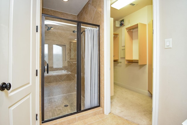 1611 Whitfield St, Sugar Land, TX 77479 - full bath with a stall shower, tile patterned flooring, a walk in closet, and baseboards