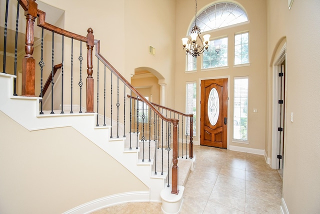 1611 Whitfield St, Sugar Land, TX 77479 - foyer with healthy amount of natural light, arched walkways, a chandelier, a towering ceiling, and baseboards