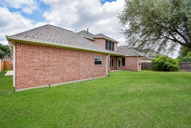1611 Whitfield St, Sugar Land, TX 77479 - rear view of property featuring roof with shingles and brick siding