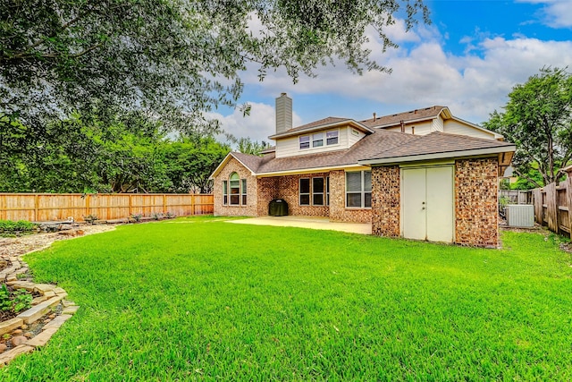2102 Ivy Cove Ct, Katy, TX 77494 - back of house featuring central AC, a chimney, a patio, roof with shingles, and brick siding