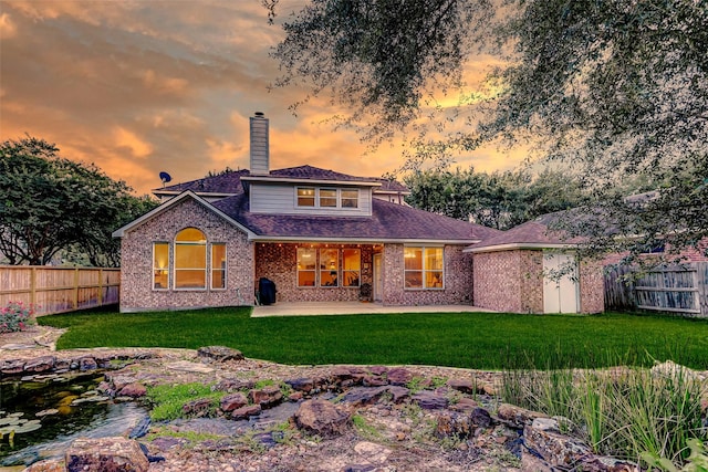 2102 Ivy Cove Ct, Katy, TX 77494 - back of property with a chimney, a patio, brick siding, and a shingled roof