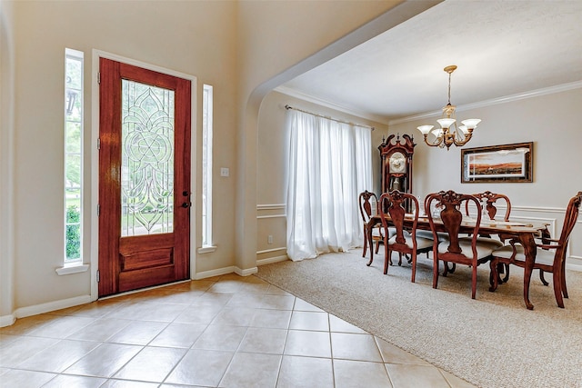 2102 Ivy Cove Ct, Katy, TX 77494 - foyer with a chandelier, light tile patterned flooring, ornamental molding, arched walkways, and baseboards