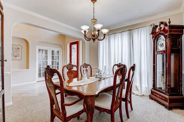 2102 Ivy Cove Ct, Katy, TX 77494 - dining space with a chandelier, crown molding, arched walkways, light colored carpet, and light tile patterned floors