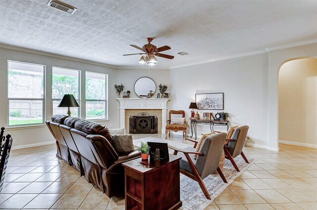 2102 Ivy Cove Ct, Katy, TX 77494 - living room featuring arched walkways, light tile patterned floors, plenty of natural light, ceiling fan, and ornamental molding