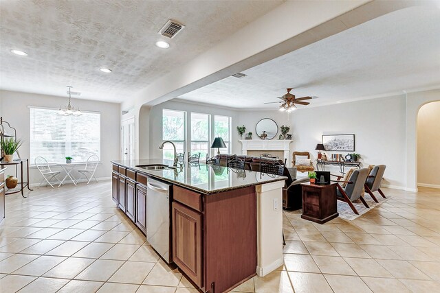 2102 Ivy Cove Ct, Katy, TX 77494 - kitchen featuring dishwasher, arched walkways, a sink, ceiling fan, and light tile patterned floors