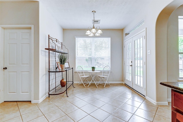 2102 Ivy Cove Ct, Katy, TX 77494 - dining area with arched walkways, light tile patterned floors, and healthy amount of natural light