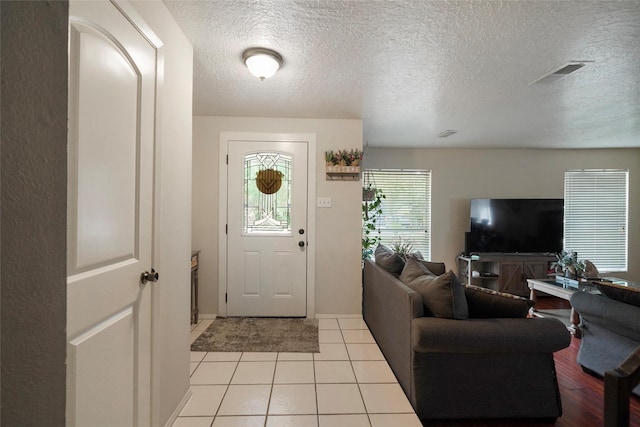 33 Coralberry Rd, The Woodlands, TX 77381 - foyer entrance featuring a textured ceiling and light tile patterned floors