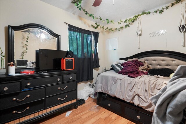 33 Coralberry Rd, The Woodlands, TX 77381 - bedroom with wood finished floors and a ceiling fan
