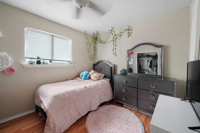 33 Coralberry Rd, The Woodlands, TX 77381 - bedroom featuring wood finished floors, a ceiling fan, and baseboards