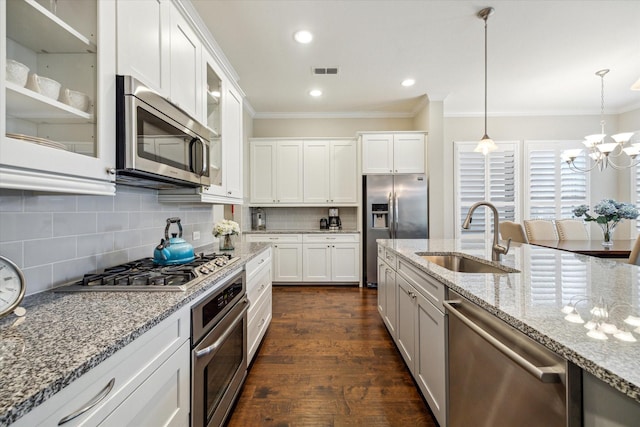 8918 Aventino Way, Houston, TX 77080 - kitchen with appliances with stainless steel finishes, a sink, crown molding, backsplash, and white cabinetry