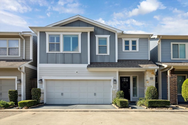 8918 Aventino Way, Houston, TX 77080 - townhome / multi-family property featuring board and batten siding, stone siding, an attached garage, and concrete driveway