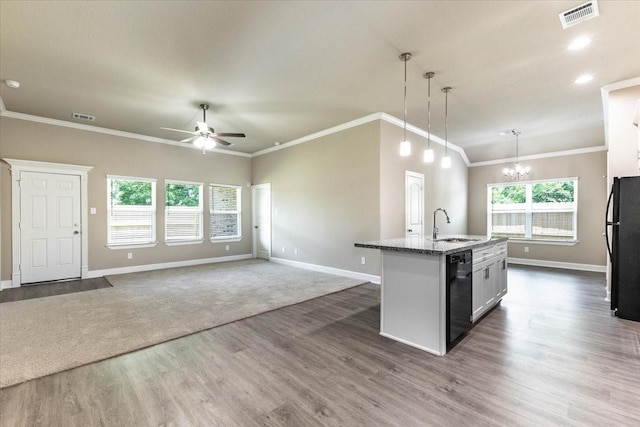6507 Radcliffe St, Houston, TX 77091 - kitchen with black appliances, dark wood-type flooring, baseboards, a ceiling fan, and a chandelier