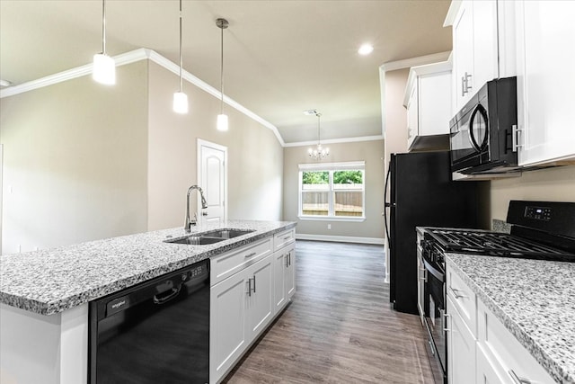 6507 Radcliffe St, Houston, TX 77091 - kitchen featuring black appliances, a sink, ornamental molding, a center island with sink, and wood finished floors