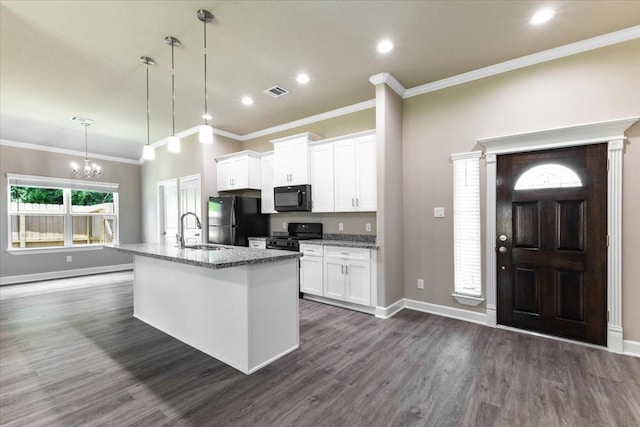 6507 Radcliffe St, Houston, TX 77091 - kitchen with black appliances, a sink, an island with sink, dark wood-style flooring, and a chandelier