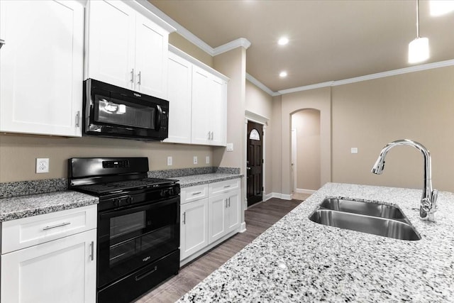 6507 Radcliffe St, Houston, TX 77091 - kitchen with black appliances, a sink, ornamental molding, dark wood-type flooring, and white cabinets