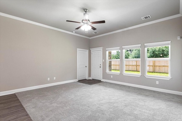 6507 Radcliffe St, Houston, TX 77091 - empty room with baseboards, a ceiling fan, ornamental molding, and dark colored carpet