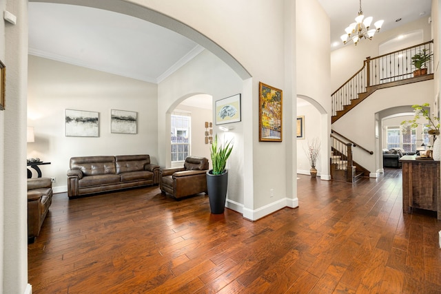 6019 Majestic Pines Dr, Houston, TX 77345 - living room featuring plenty of natural light, stairway, crown molding, baseboards, and dark wood finished floors