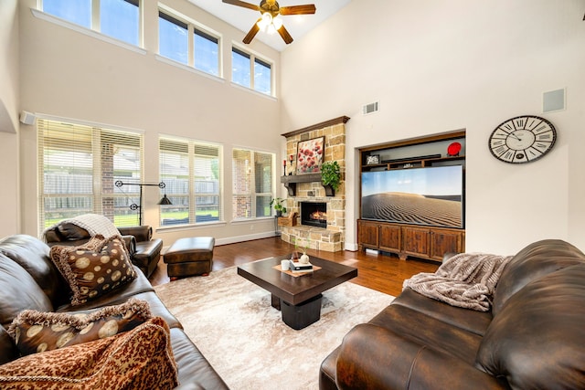 6019 Majestic Pines Dr, Houston, TX 77345 - living area featuring a ceiling fan, a towering ceiling, wood finished floors, and a fireplace