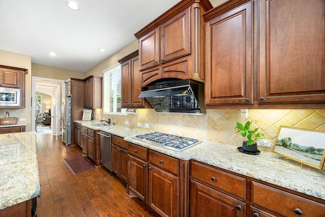 6019 Majestic Pines Dr, Houston, TX 77345 - kitchen with stainless steel appliances, light stone counters, dark wood-style floors, a sink, and decorative backsplash