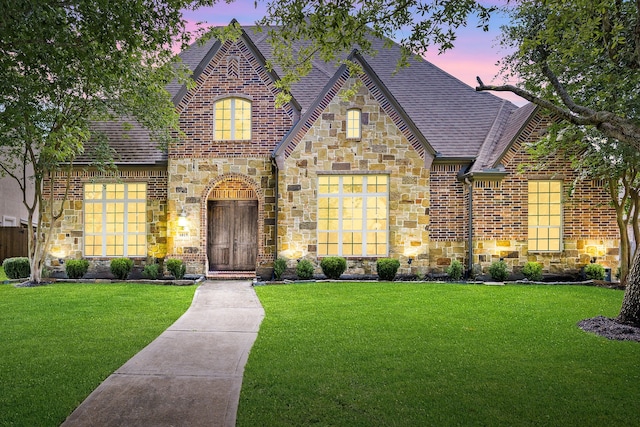 6019 Majestic Pines Dr, Houston, TX 77345 - view of front of house featuring stone siding, roof with shingles, a yard, and brick siding
