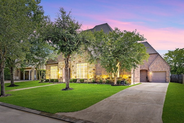 6019 Majestic Pines Dr, Houston, TX 77345 - view of front facade featuring concrete driveway, a lawn, a garage, and brick siding