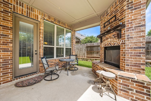 6019 Majestic Pines Dr, Houston, TX 77345 - view of patio with an outdoor brick fireplace