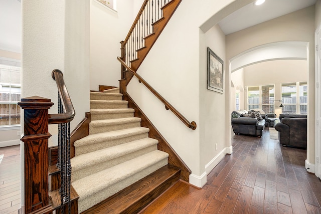 6019 Majestic Pines Dr, Houston, TX 77345 - stairway featuring arched walkways, hardwood / wood-style flooring, baseboards, and recessed lighting