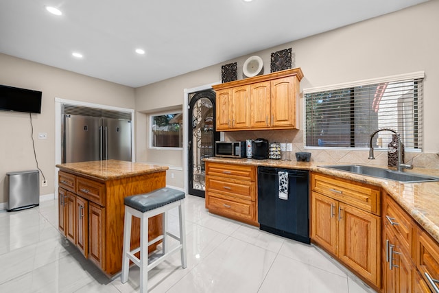 3002 Ashford Oak Dr, Houston, TX 77082 - kitchen with appliances with stainless steel finishes, a sink, light stone counters, a kitchen bar, and recessed lighting