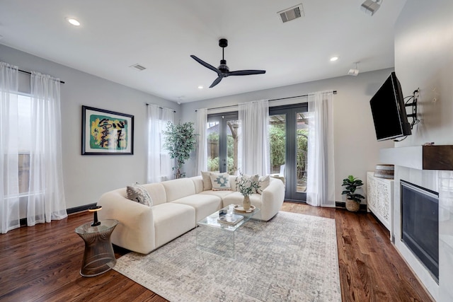 1540 Lawrence St, Houston, TX 77008 - living room with a ceiling fan, dark wood-type flooring, a glass covered fireplace, recessed lighting, and baseboards