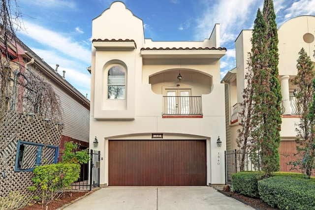 1540 Lawrence St, Houston, TX 77008 - view of front facade featuring stucco siding, driveway, an attached garage, a balcony, and a tile roof