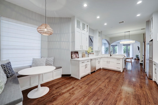1540 Lawrence St, Houston, TX 77008 - kitchen with a sink, a peninsula, white cabinets, dark wood-style floors, and recessed lighting