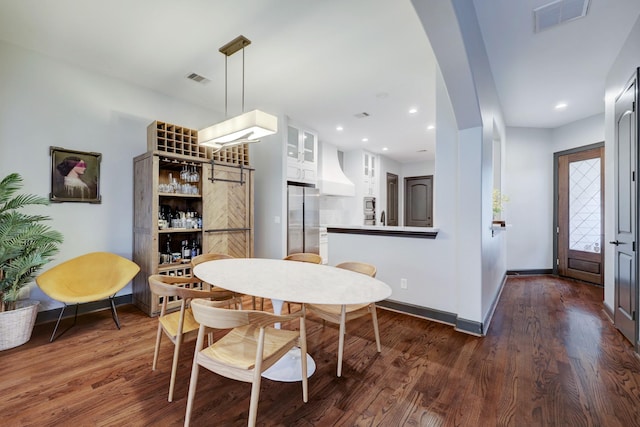 1540 Lawrence St, Houston, TX 77008 - dining room with dark wood-style flooring, baseboards, arched walkways, and recessed lighting