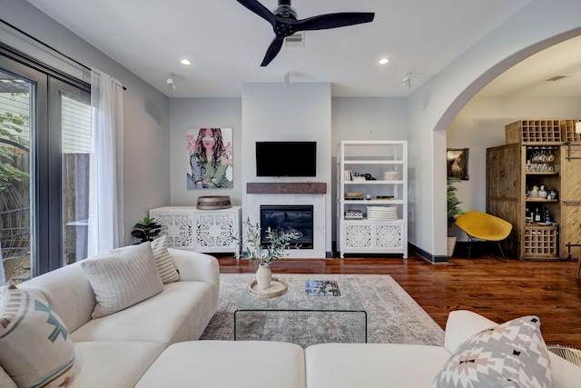 1540 Lawrence St, Houston, TX 77008 - living area with wood finished floors, arched walkways, ceiling fan, a glass covered fireplace, and recessed lighting